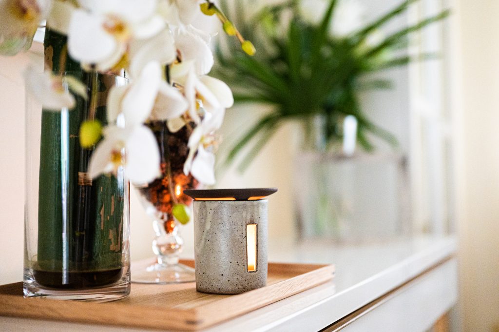 White flower pot and light lamp on table